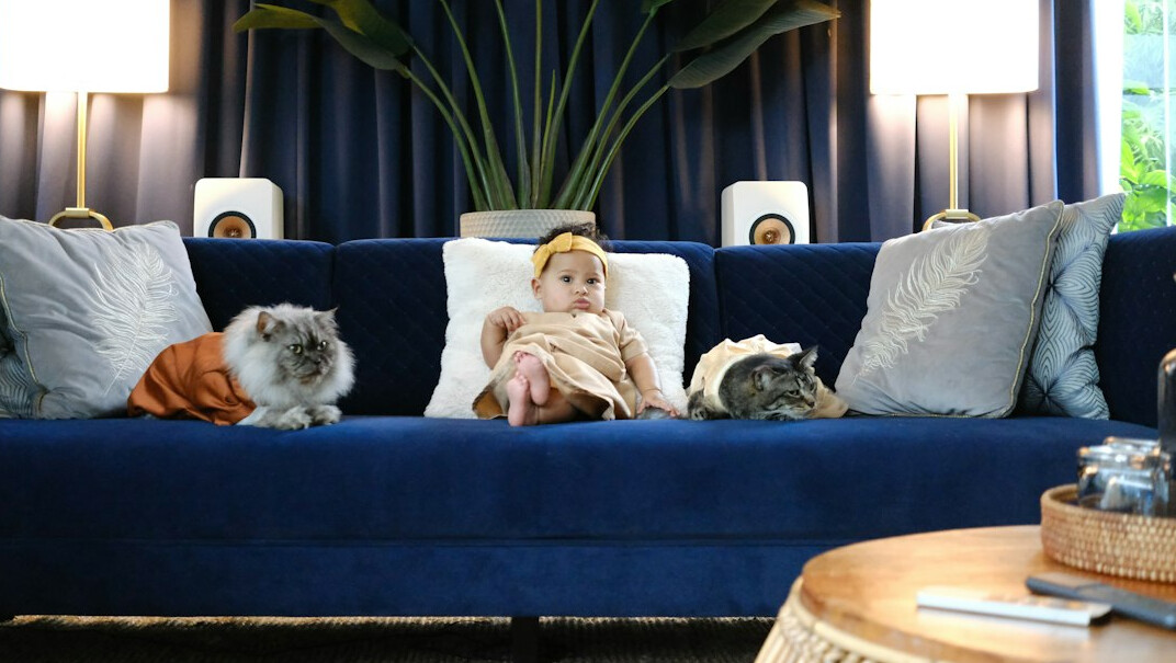 Happy family with two children sitting together on a sofa