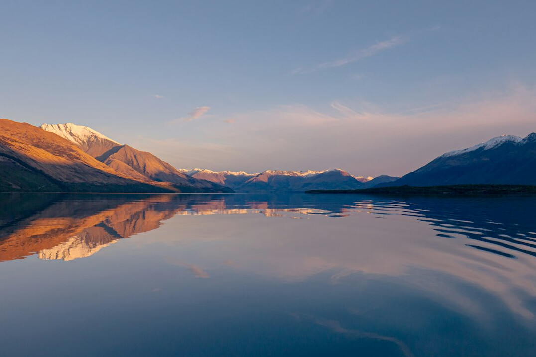 Calm mountain lake landscape at sunrise