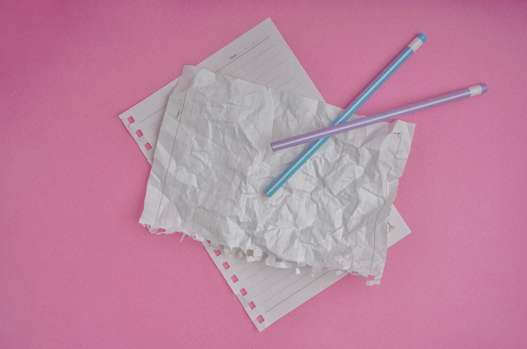 Stack of paper documents with a pen